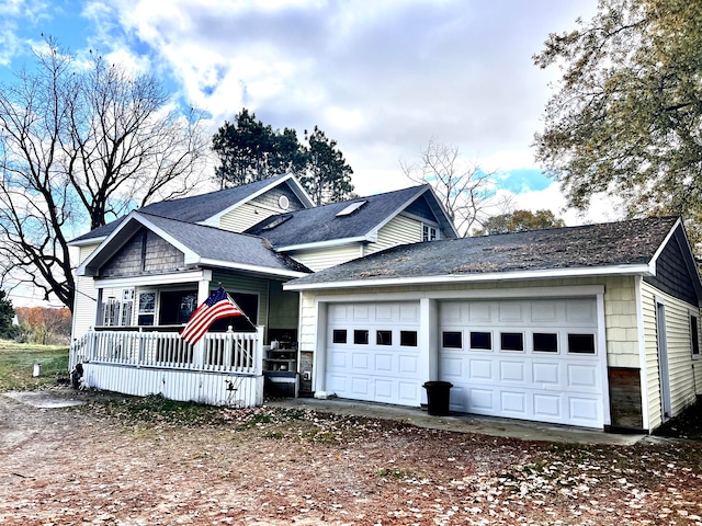 view of front of property with covered porch and a garage