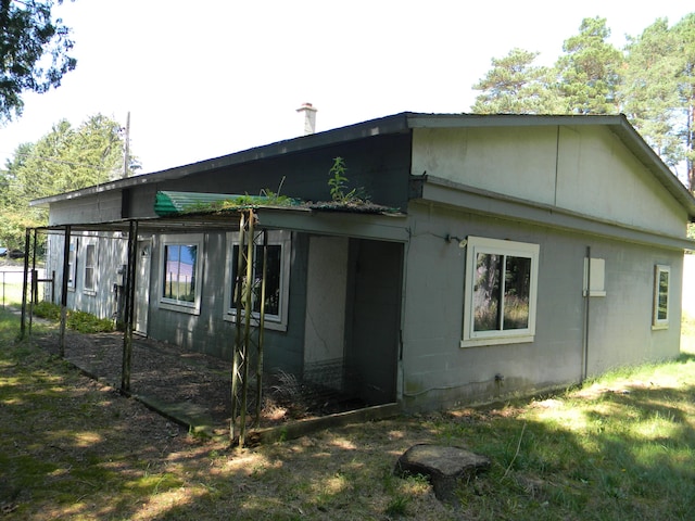 view of side of home featuring concrete block siding