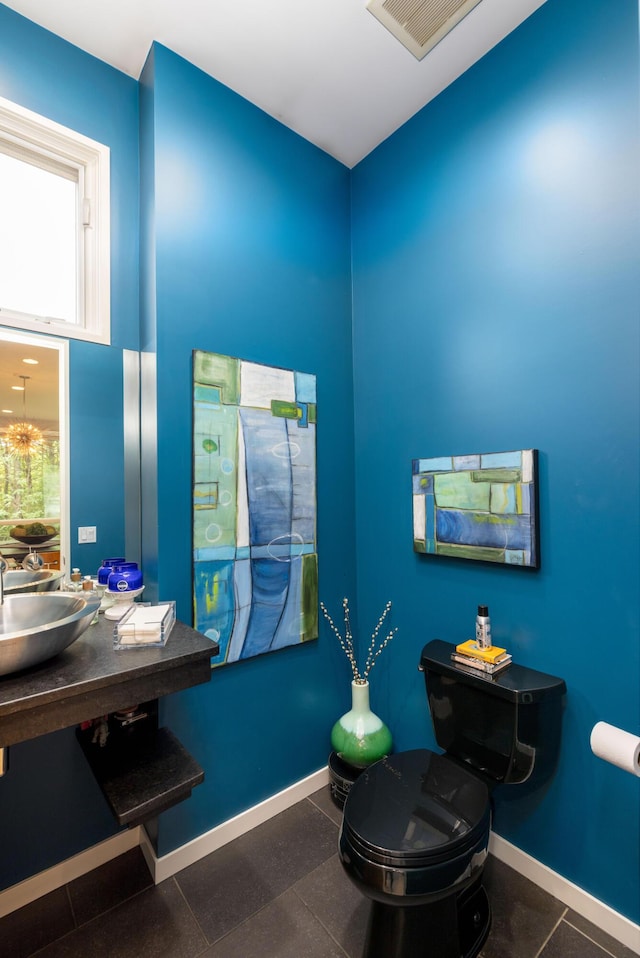 12737 Sanctuary Pl, Grand Haven, MI 49417 - half bath with baseboards, a sink, and toilet