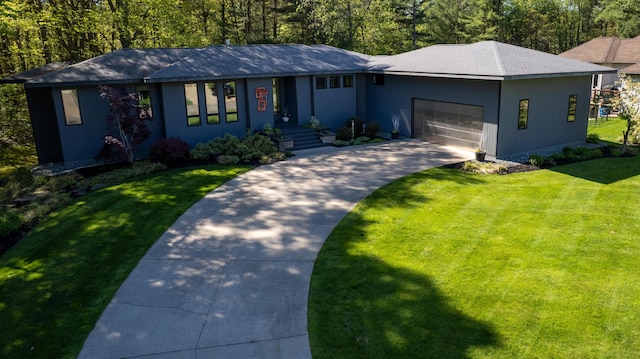 12737 Sanctuary Pl, Grand Haven, MI 49417 - view of front facade with concrete driveway, an attached garage, and a front lawn