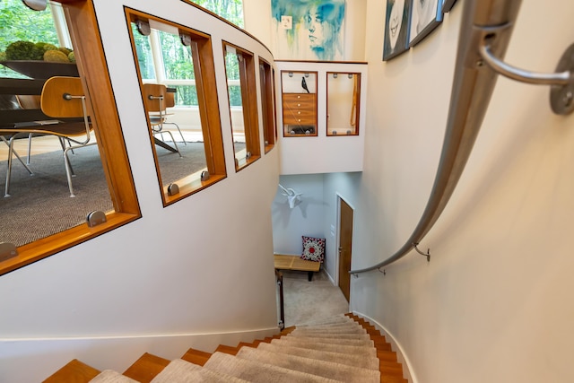 12737 Sanctuary Pl, Grand Haven, MI 49417 - staircase featuring plenty of natural light and a towering ceiling