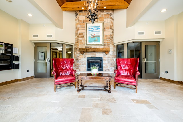 living room featuring beamed ceiling, tile patterned floors, a fireplace, and brick wall