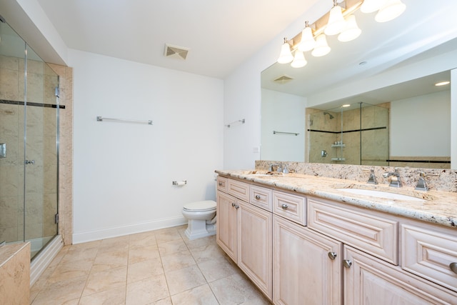 bathroom featuring dual vanity, toilet, tile patterned floors, and an enclosed shower