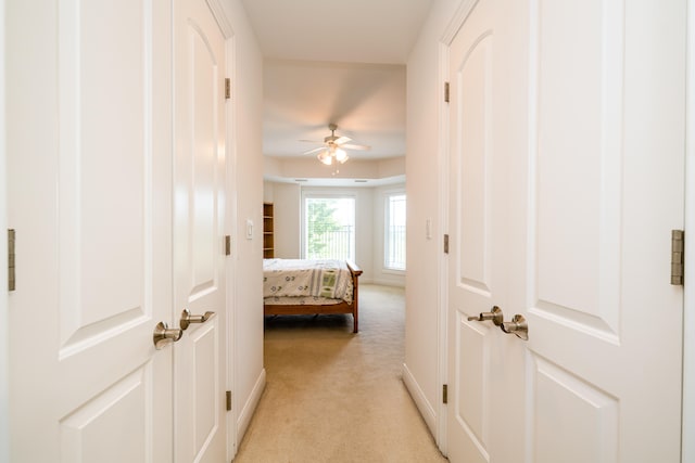 hall featuring light colored carpet