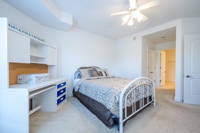 bedroom with light carpet, baseboards, and a ceiling fan