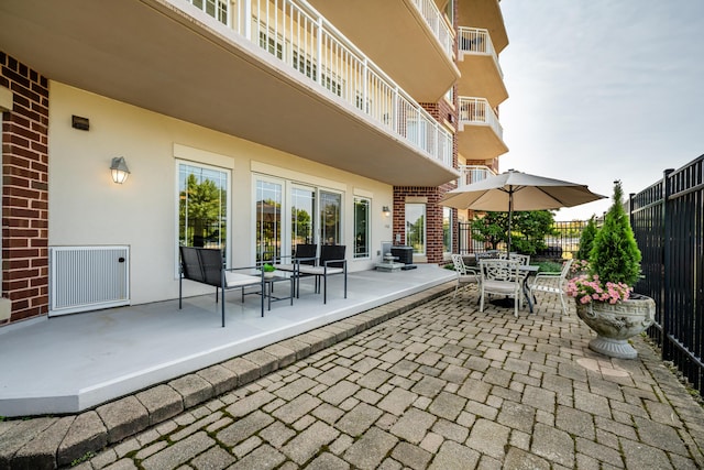 view of patio / terrace with visible vents, outdoor dining area, and fence