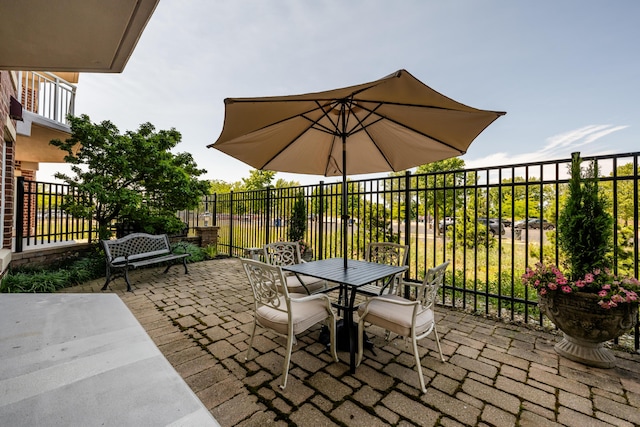 view of patio / terrace with outdoor dining area and fence