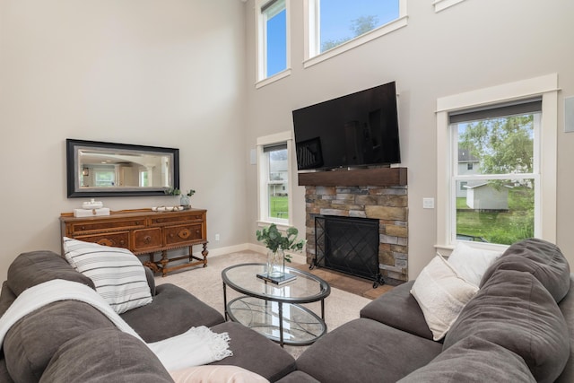 living room with a towering ceiling and a fireplace