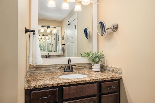 bathroom featuring tasteful backsplash and vanity