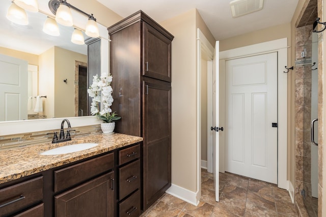 bathroom featuring walk in shower and vanity