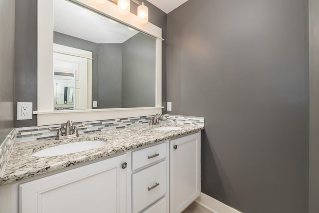 bathroom with tasteful backsplash and vanity