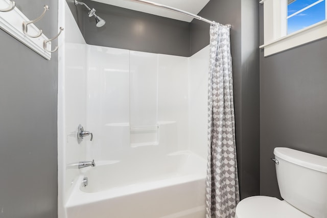 bathroom featuring shower / bathtub combination with curtain and toilet