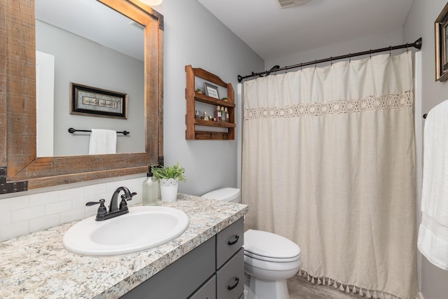 bathroom with tasteful backsplash, vanity, toilet, and a shower with shower curtain