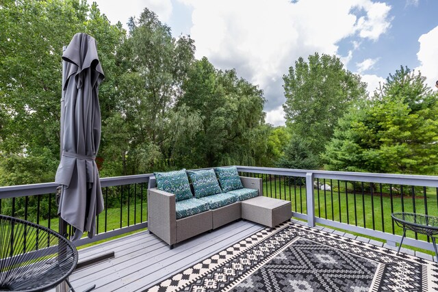 wooden deck with a yard and an outdoor hangout area