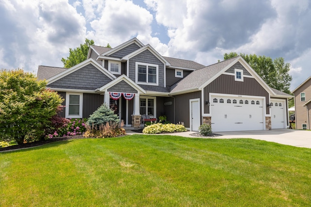 craftsman house with a garage and a front lawn