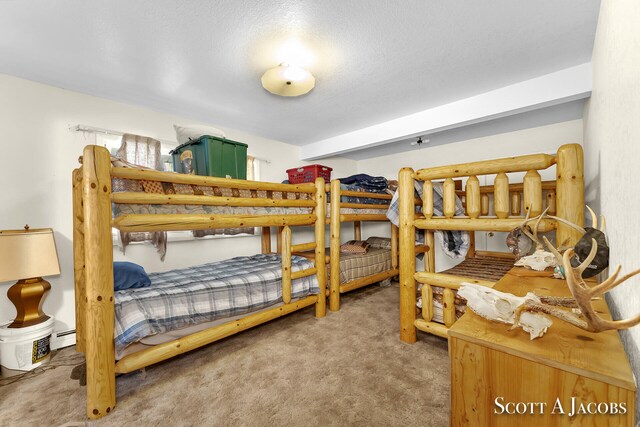 bedroom featuring a textured ceiling and carpet floors