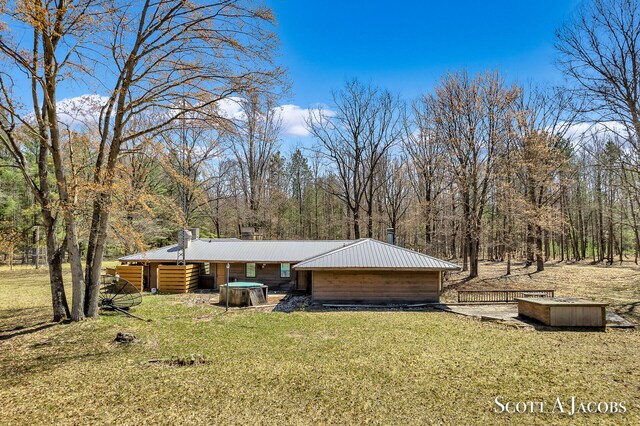 view of front of house with a front lawn and a jacuzzi