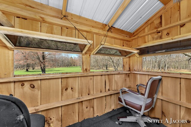 sunroom featuring vaulted ceiling