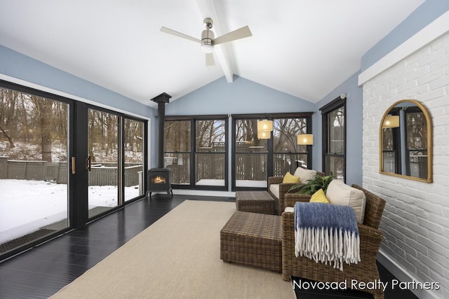 sunroom with ceiling fan and lofted ceiling with beams