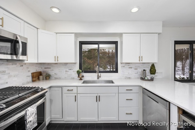 kitchen featuring white cabinetry, appliances with stainless steel finishes, sink, and tasteful backsplash