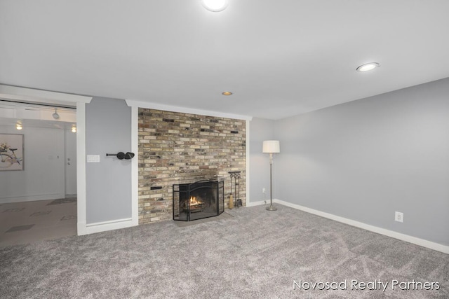 unfurnished living room with a fireplace and carpet