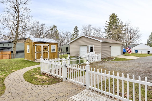 view of front of home with an outbuilding, a detached garage, and fence