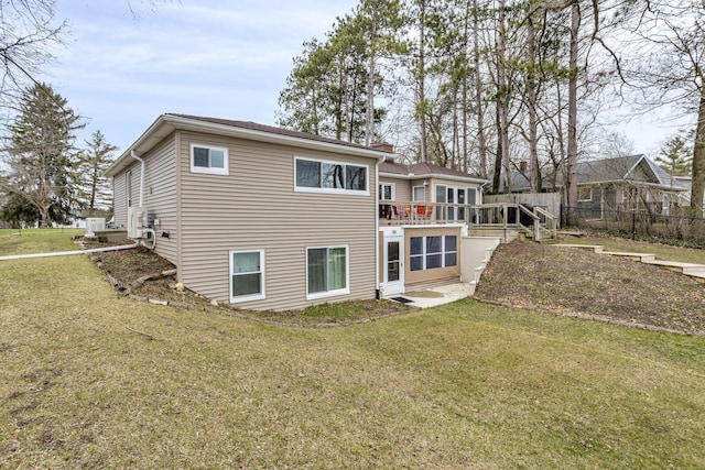 back of property with a yard and a wooden deck