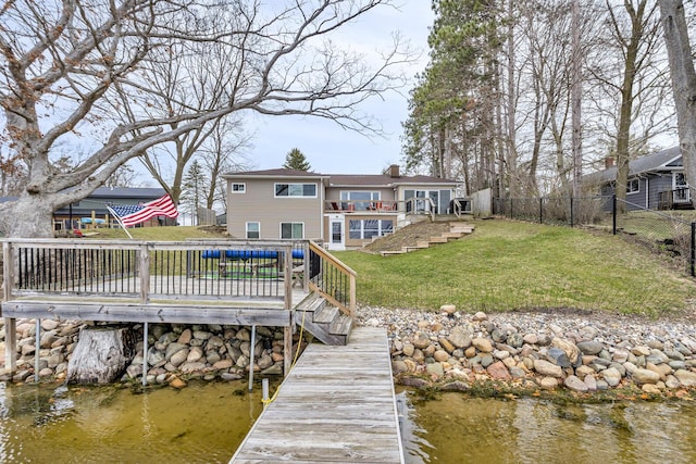 view of dock featuring stairs, a fenced backyard, a wooden deck, and a lawn