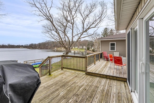 deck featuring a water view and grilling area