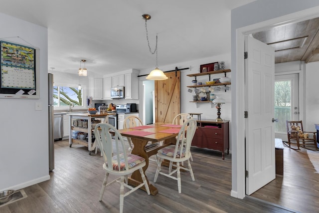 dining space featuring baseboards and dark wood finished floors