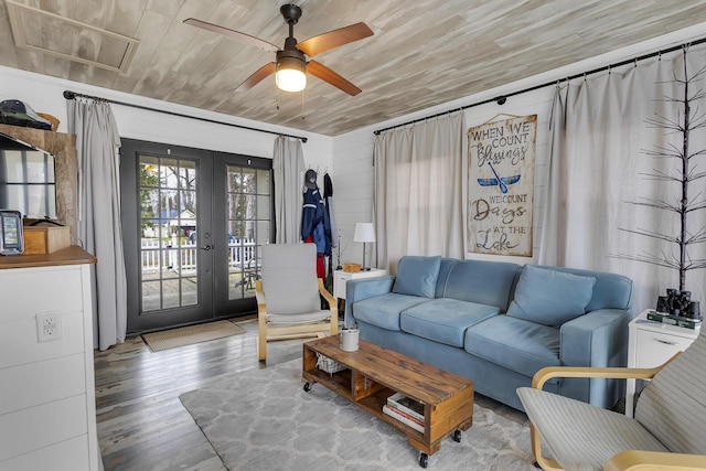 living room featuring french doors, ceiling fan, wooden ceiling, and wood finished floors