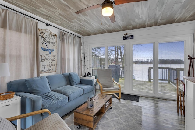 living room featuring a water view, ceiling fan, wooden ceiling, and wood finished floors