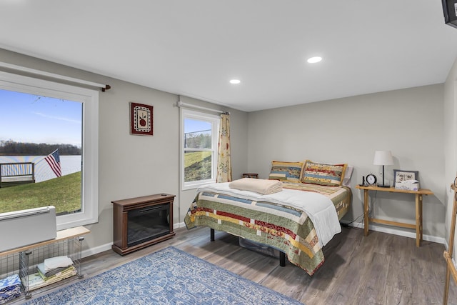 bedroom with baseboards, recessed lighting, and wood finished floors