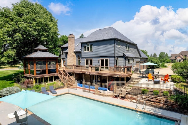 view of pool with a gazebo, a patio area, and a wooden deck