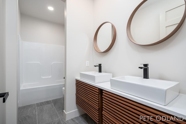 full bathroom featuring vanity,  shower combination, and toilet