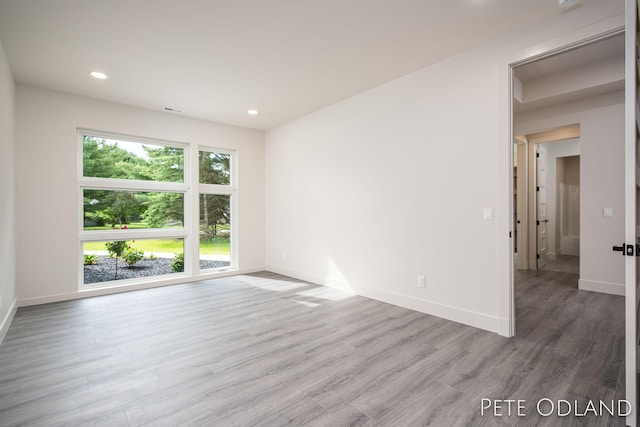 spare room featuring hardwood / wood-style flooring