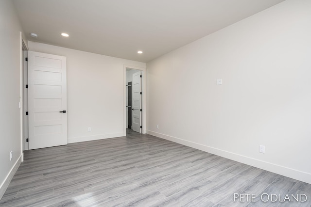 unfurnished room with light hardwood / wood-style floors