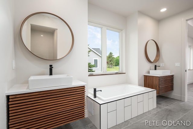 bathroom with vanity and a bathtub