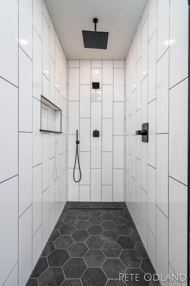 bathroom with a shower and tile walls