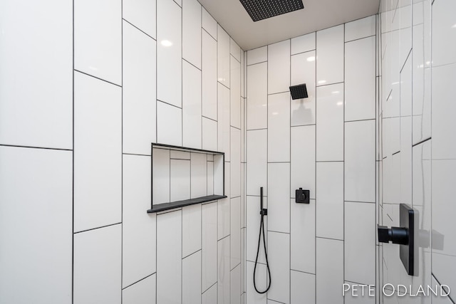 room details featuring a tile shower and a package area