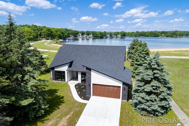 birds eye view of property with a water view