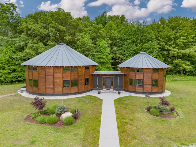 rear view of house featuring a lawn and a sunroom