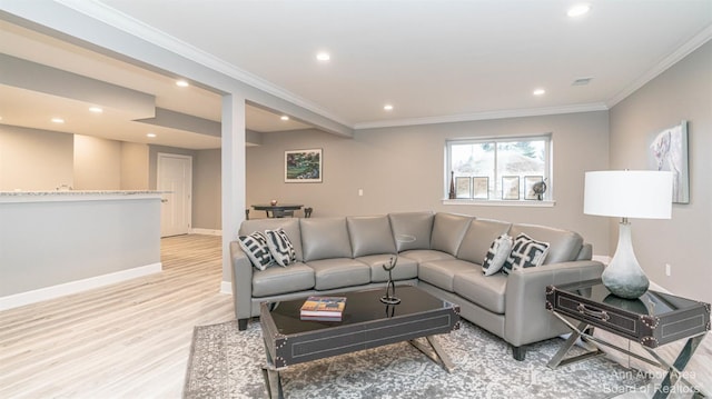 living room with crown molding and light hardwood / wood-style flooring