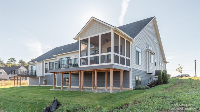 rear view of house featuring a sunroom, central air condition unit, and a lawn