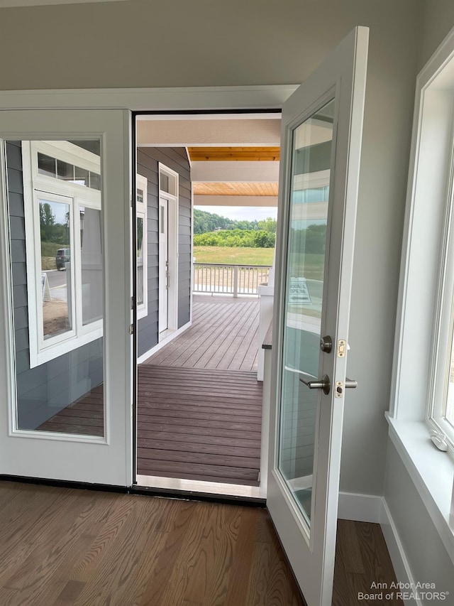 doorway with dark hardwood / wood-style floors and french doors