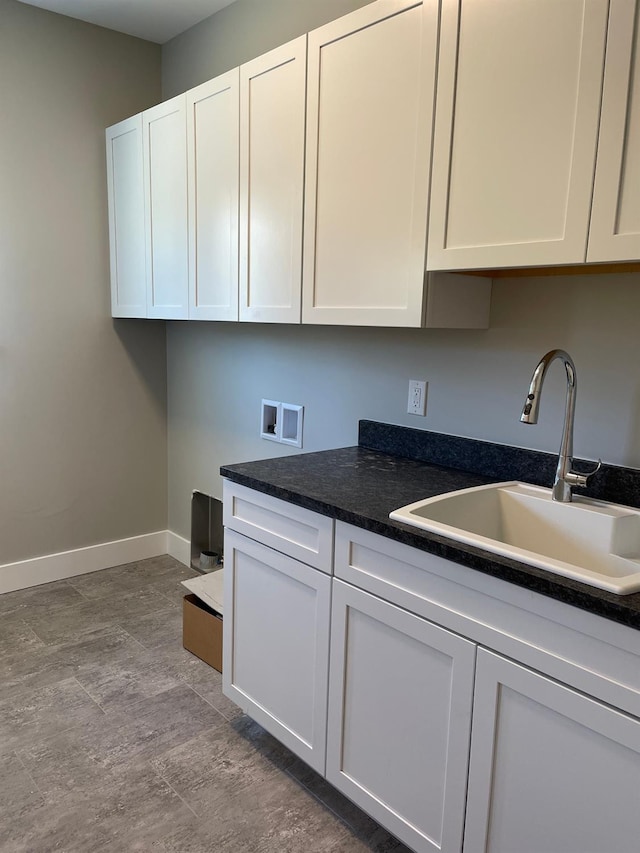 kitchen with white cabinetry and sink