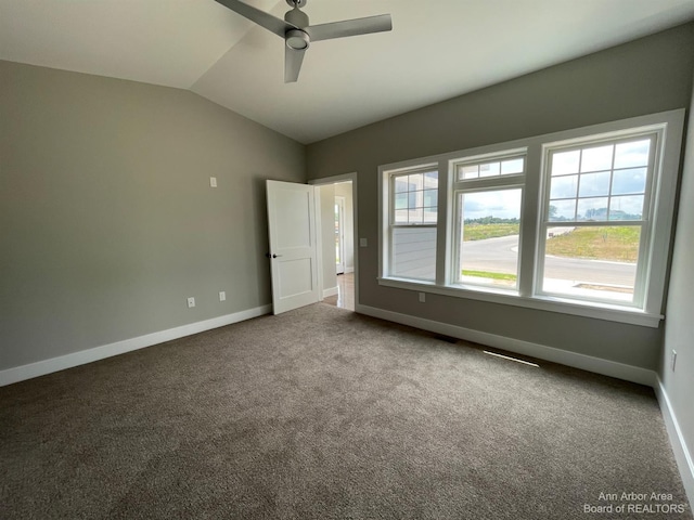 unfurnished bedroom featuring ceiling fan, carpet floors, and vaulted ceiling