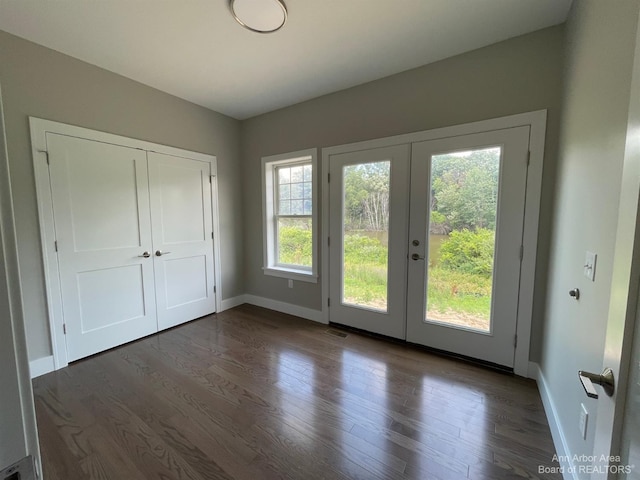 doorway to outside with dark hardwood / wood-style floors, plenty of natural light, and french doors