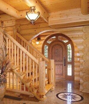 foyer with stairway, arched walkways, wooden ceiling, beamed ceiling, and rustic walls