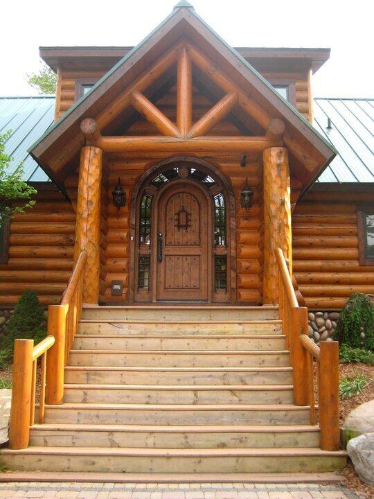 entrance to property featuring metal roof and log exterior